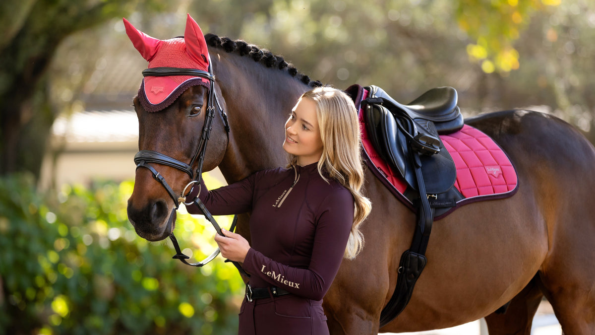 LeMieux Loire Close Contact Saddle Pad in Cranberry red with shimmering satin fabric and embossed metal logo.