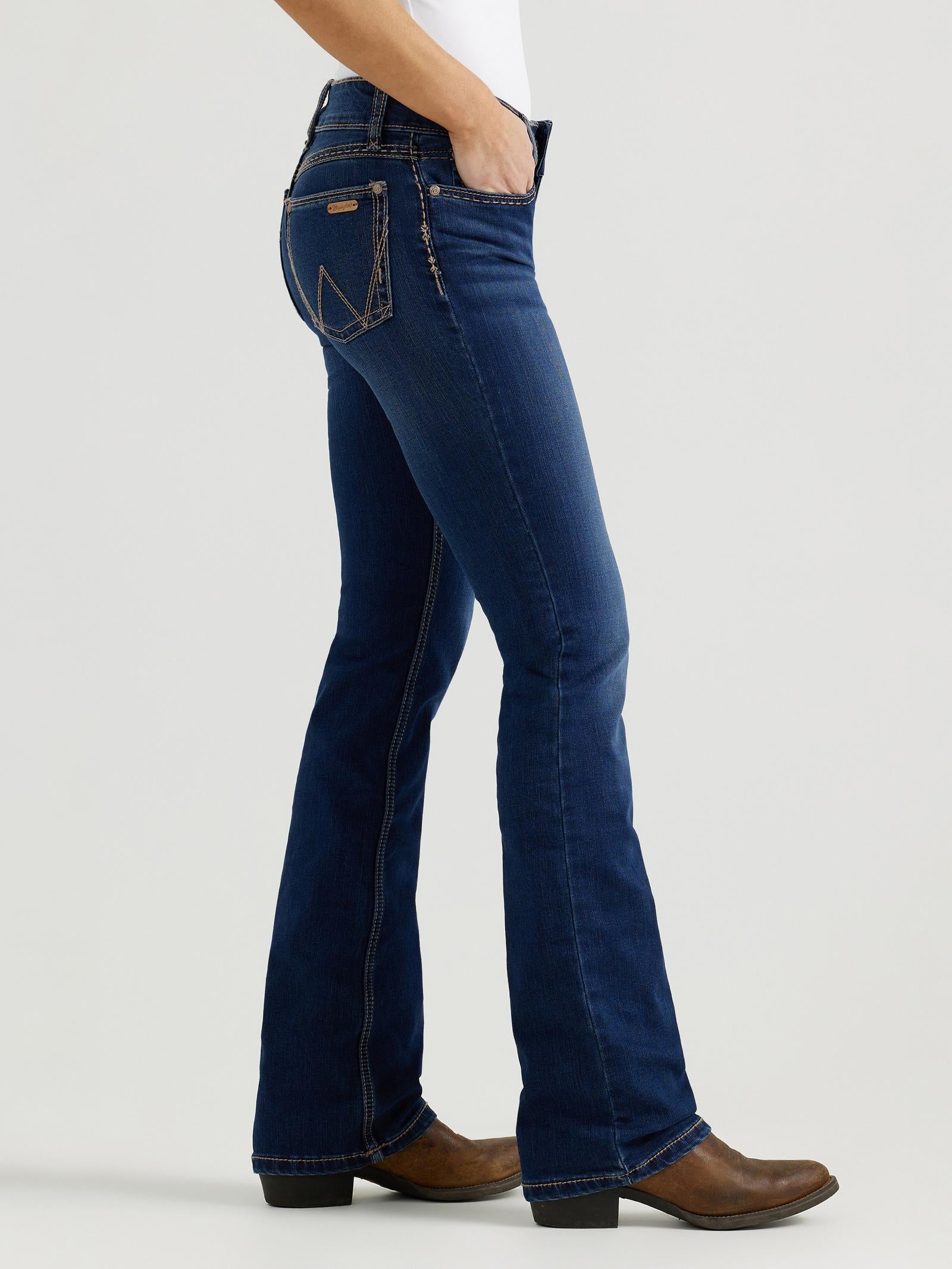 Person wearing blue jeans and brown boots on a white background