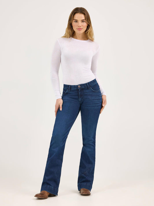 Woman wearing blue jeans and a white top on a white background
