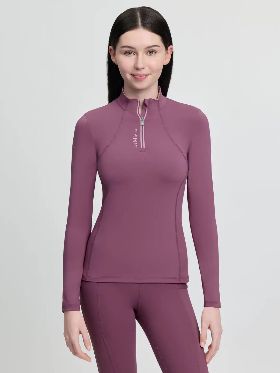 LeMieux Young Rider Base Layer in Mallow Pink featuring moisture-wicking thermal fabric, a quarter-zip neck, and silver logo detailing