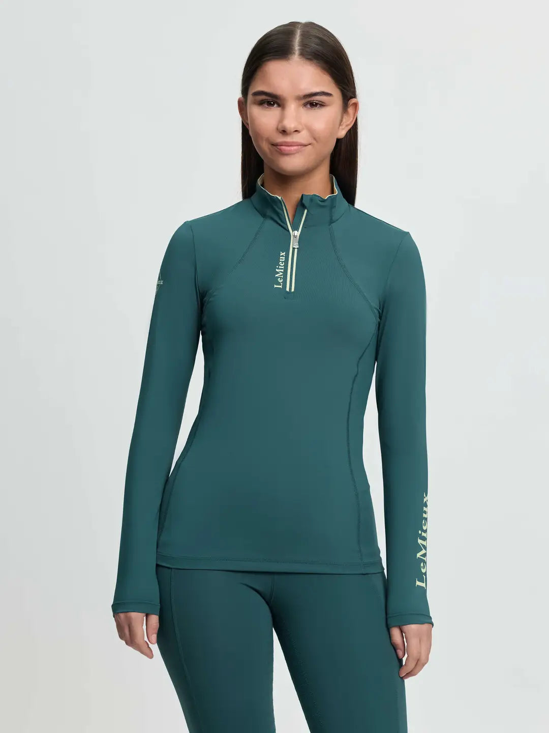 LeMieux Young Rider Base Layer in Jungle Green featuring moisture-wicking thermal fabric, a quarter-zip neck and silver logo branding 